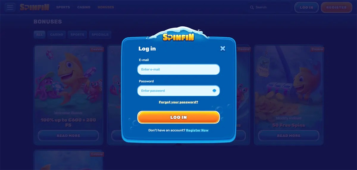 Login modal for Spinfin Casino featuring email and password input fields, a “Forgot your password?” link, a prominent “LOG IN” button, and a registration prompt, all styled in a rounded blue UI overlay with a blurred casino background